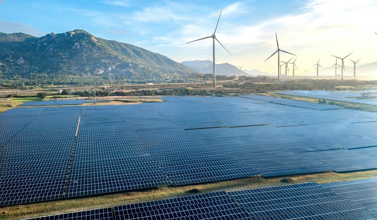 Solar farm with wind turbines representing renewable energy forecasting